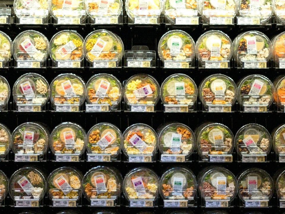 Packaged, labeled salad bowls in a store cooler